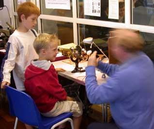 Our fast
                    moving Secretary entertaining two young visitors