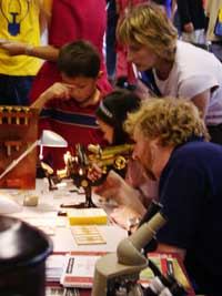 Graham Marsh adjusting a
                  fine antique microscope